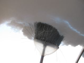 sweeping snow from hoophouse roof